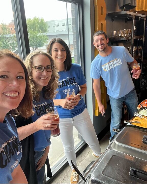 Kate Kotzea, Julie Waage, Angie Lammers, and Keith Cutler serving walking tacos during the 2023 Campaign Kickoff event at Severance Brewing.