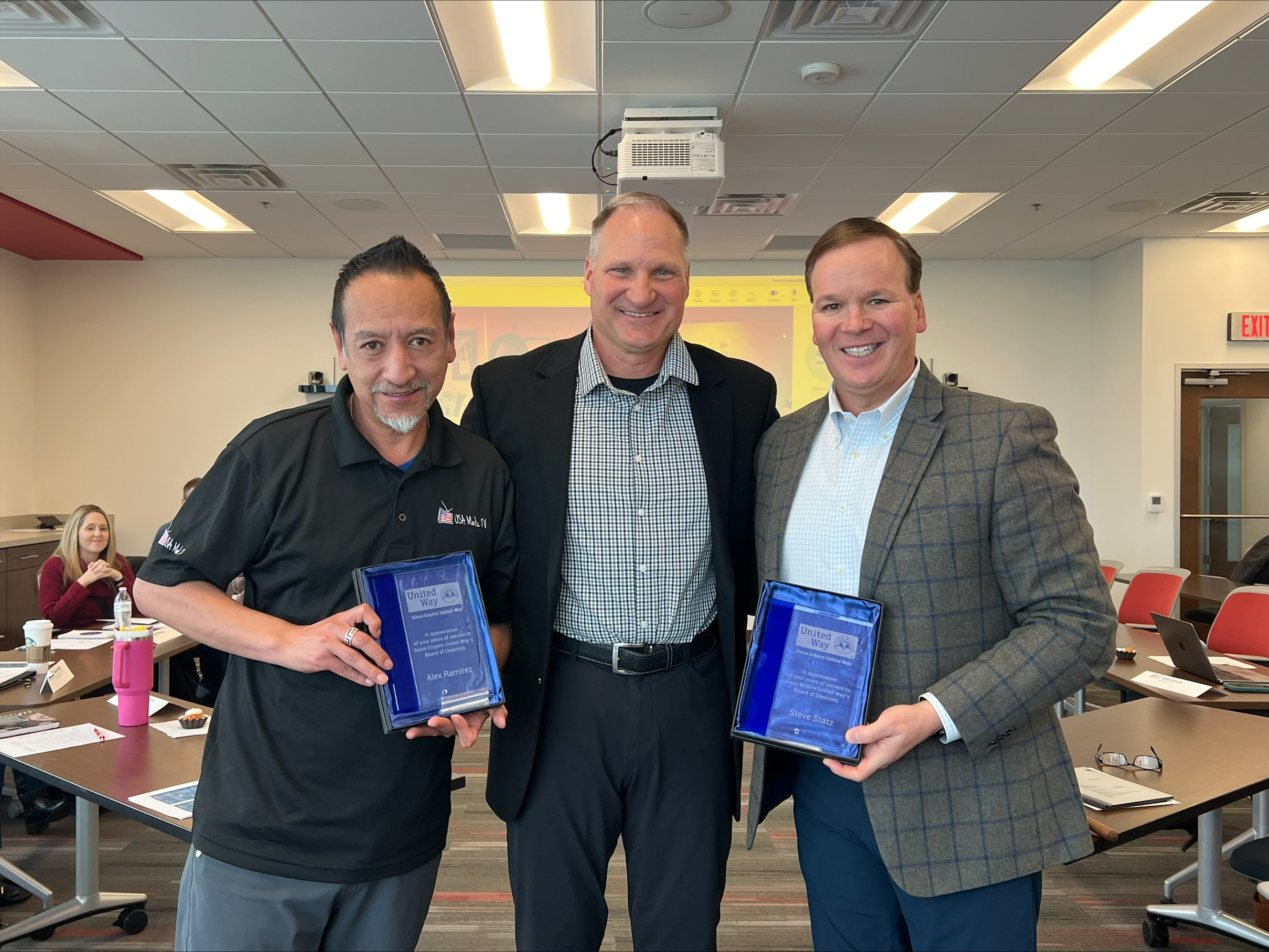 Alex Ramirez, Randy Knecht, and Steve Statz photographed with exiting board member plaques.