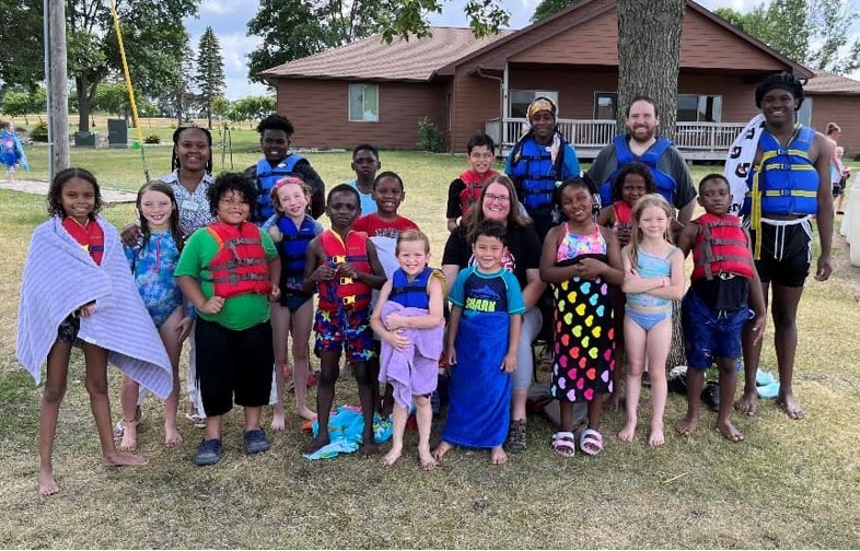 Group photo of Kidstop teachers, volunteers, and children at Lake Poinsett Camp