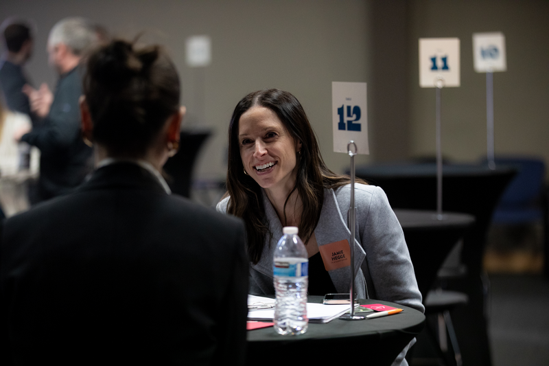 Jamie Hegge having a one on one conversation at a table. 