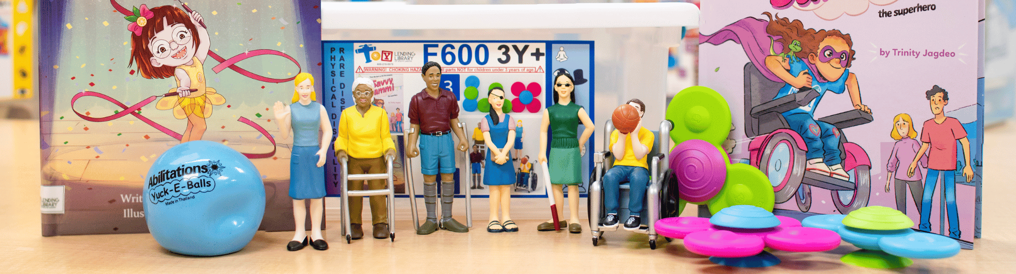 Books, toys, and items displayed from the Toy Lending Library Physical Disability and Rare Disease box.