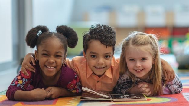 Children smiling with books